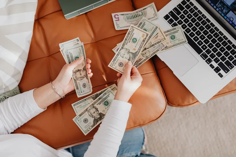 Person reviewing earnings on a laptop after completing part-time VA work