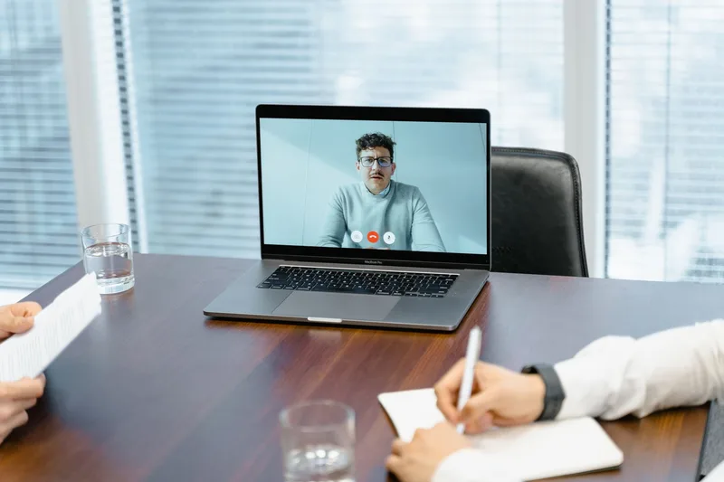 Professional taking a client video call on a laptop