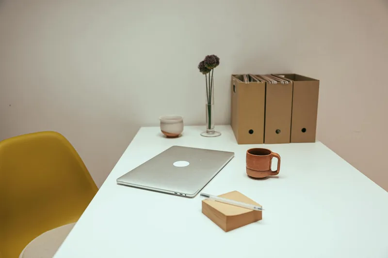 Organized workspace with laptop showing clean digital file management system